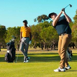 man hitting the ball with golf stick