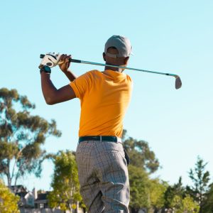 man hitting the ball with golf stick