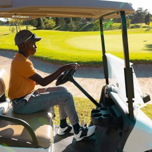 man driving golf cart